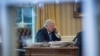 FILE - President Donald Trump speaks on the phone in the Oval Office at the White House in Washington, Jan. 28, 2017.