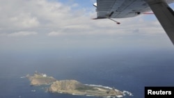 Handout photograph taken on a marine surveillance plane B-3837 shows the disputed islets, known as Senkaku in Japan and Diaoyu in China, December 13, 2012.