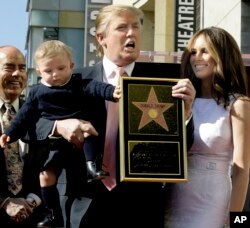 Donald Trump, the billionaire developer, and producer of NBC's "The Apprentice," with his wife, Melania Knauss, and their son, Barron, pose for a photo after he was honored with a star on the Hollywood Walk of Fame in Los Angeles, Tuesday, Jan. 16, 2007.