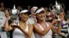 Su-Wei Hsieh of Taiwan, left, and Shuai Peng of China pose with their trophies after winning against Ashleigh Barty of Australia and Casey Dellacqua of Australia in the Women's doubles final match at the All England Lawn Tennis Championships in Wimbledon,