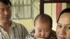 Taiwanese security guard Huang Chin-tsai, 44, looks at his his wife, Vu Thi Minh, 30, from Vietnam and their six-month-old daughter in their home, in Wanli, 30 miles north of Taipei, Taiwan, March 1, 2003.