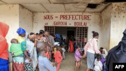 FILE - Refugees from the Central African Republic wait in line to be registered, in front of municipal administrative offices in Garoua-Boulai, Cameroon, Jan. 8, 2021.