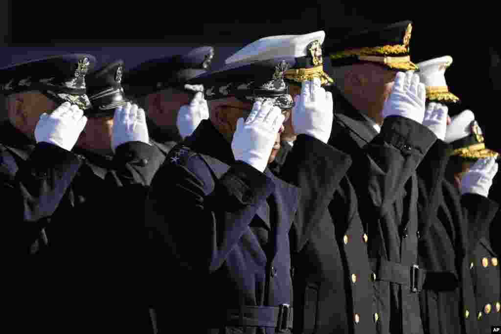 Chairman of the Joint Chiefs of Staff Gen. CQ Brown, center, salutes the flag-draped casket of former President Jimmy Carter Washington National Cathedral in Washington, Jan. 9, 2025, for a state funeral.