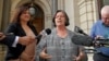 State Greens member for Western Metro Colleen Hartland and Greens member for South Eastern Metro Nina Springle give their reactions outside Parliament House during a news conference after an assisted dying vote in Melbourne, Australia, Nov. 29, 2017.