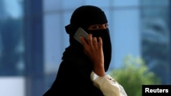 FILE - A Saudi woman speaks on the phone in Riyadh, Saudi Arabia, Oct. 2, 2017.