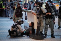 Police detain a protester during a march marking the anniversary of the Hong Kong handover from Britain to China, in Hong Kong, July. 1, 2020.