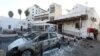 FILE - People inspect the damage at Ahli Arab Hospital in central Gaza on Oct. 18, 2023, following a blast that ripped through it a day earlier. The U.S. and Israel have cast doubt on the veracity of the death tolls being reported by the Hamas-controlled Ministry of Health.
