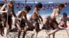 Traditonally dressed Australian Aboriginal performers participate in a 'Corroboree' showcasing traditional dance during an event to mark National Reconciliation Week on Sydney's Coogee Beach May 27, 2015.