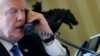 FILE - U.S. President Donald Trump speaks by phone with Russia's President Vladimir Putin in the Oval Office at the White House in Washington, Jan. 28, 2017. 