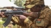 FILE - Burkinabe Soldiers perform a tactical reload drill near Po, Burkina Faso, Feb. 17, 2019. 