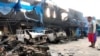 A man looks at damaged vehicles in front of Indonesia's Customs and Excise Office after a riot in Jayapura, Papua, Indonesia, Aug. 30, 2019, in this photo taken by Antara Foto. 
