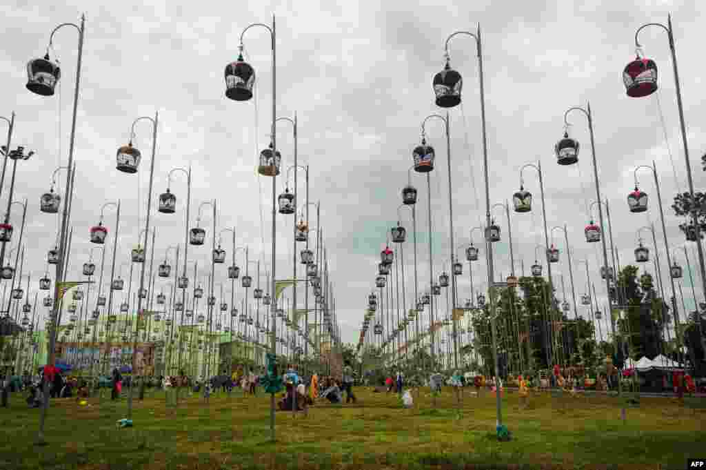 Birds sit in their cages, hoisted on poles during a bird-singing contest in Thailand&#39;s southern province of Narathiwat, Sept. 20, 2016.