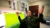Jeff Muhs, of Utah State University's Energy Laboratory in Logan, Utah, sits next to a tank of algae on June 11, 2009, as he talks about how his team of scientists are looking for ways to convert algae into biofuels for military jets.