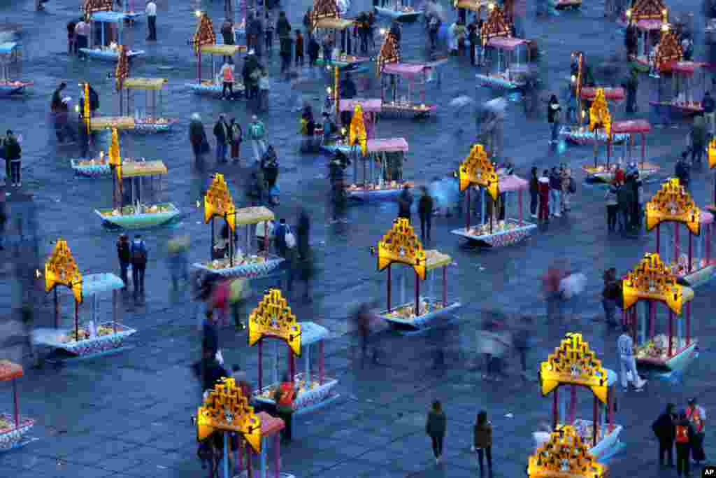 Representations of boats known as "trajineras" are on display in Mexico City's main square, the Zocalo, as part of the Day of the Dead festivities in Mexico City, Oct. 31, 2016.