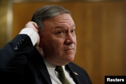 CIA Director Mike Pompeo responds to questions from Sen. Cory Booker as Pompeo testifies before a Senate Foreign Relations Committee confirmation hearing on Pompeo's nomination to be secretary of state, April 12, 2018, in Washington.