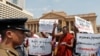 FILE - Protesters in Sri Lanka denounce the government's decision to issue death certificates for persons gone missing during country's civil war, in Colombo, Feb. 11, 2020. The placards read "Who killed the disappeared?" in Tamil and Sinhalese.