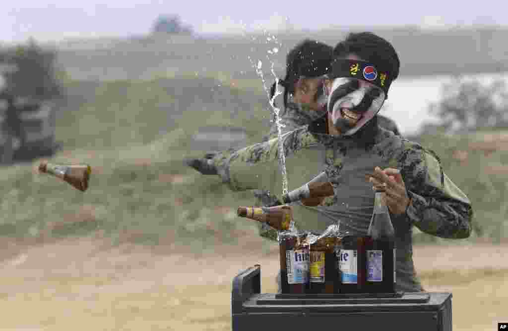 A South Korean army special forces soldier breaks bottles with his hand during the Naktong River Battle re-enactment in Waegwan.