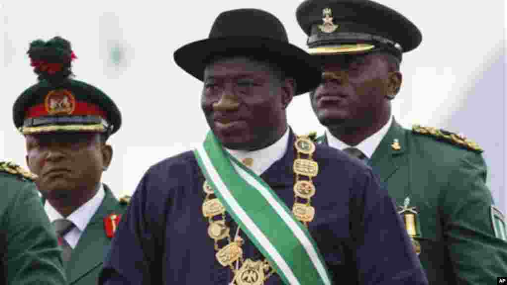 Nigerian President Goodluck Jonathan, center, inspects a guard of honor during his inauguration ceremony at the main parade ground in Nigeria's capital of Abuja, Sunday, May 29, 2011.
