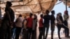 Eritrean refugees queue during a distribution of items organized the UNHCR at Mai Aini Refugee camp, in Ethiopia, Jan. 30, 2021.