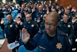 Over 300 officers from other jurisdictions, including many from the California Highway Patrol, are sworn in to have police powers in Cleveland, as preparations continue for the Republican National Convention, July 16, 2016 in Cleveland, Ohio.
