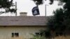 FILE - An Islamic State flag flies over the customs office of Syria's Jarablus border gate as seen from the Turkish town of Karkamis, in Gaziantep province, Turkey, Aug. 1, 2015.