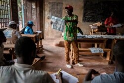 FILE - Electoral workers start to count votes at the Lycée Boganda polling station in the capital Bangui, Central African Republic, Dec. 27, 2020.