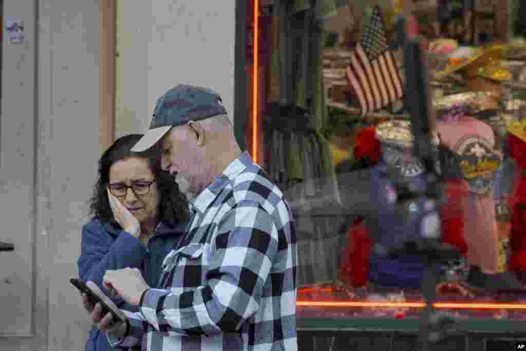 People react at the intersection of Bourbon Street and Canal Street during the investigation after a pickup truck rammed into a crowd of revelers early on New Year's Day, Jan. 1, 2025, in New Orleans.