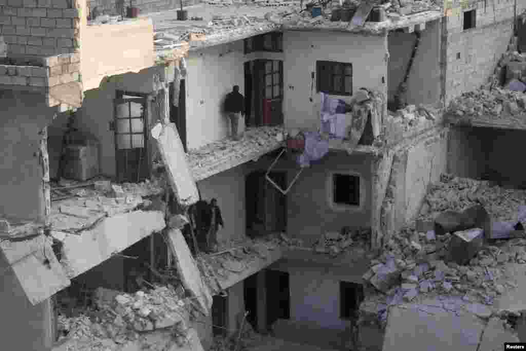 Residents inspect their houses after what activists said was an air strike by forces loyal to Syria's President Bashar Al-Assad in Al-Maysar, Aleppo, Jan. 19, 2014.