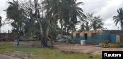 Damaged buildings are pictured from inside a vehicle after Cyclone Kenneth swept through the region in Cabo Delgado province, Mozambique, April 26, 2019, in this image obtained from social media.