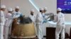 FILE - In this photo released by Xinhua News Agency, researchers prepare to weigh Chang'e 6 lunar samples at the China Academy of Space Technology under the China Aerospace Science and Technology Corporation, in Beijing on June 26, 2024. 