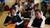 FILE - Students have a meal they received from a government sponsored feeding scheme at the Delta Primary School in Vosburg, South Africa, Nov. 14, 2019. 