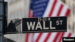 The Wall Street sign is pictured at the New York Stock exchange (NYSE) in the Manhattan borough of New York City, New York, U.S., March 9, 2020. 