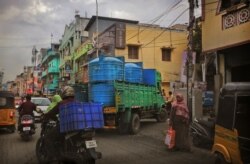 In this July 18, 2019, photo, a water truck carrying drinking water arrives at a locality in Chennai, in the Southern Indian state of Tamil Nadu.