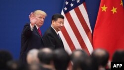 FILE - U.S. President Donald Trump and China's President Xi Jinping leave a business leaders event at the Great Hall of the People in Beijing, Nov. 9, 2017.