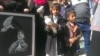 A blind child carries a dove at a protest against the attack on the al-Nour Center for the Blind on Jan. 10, 2016, in Sana'a, Yemen. Students say neither the school, nor themselves, have taken any side in the war. (A. Mojalli/VOA) 