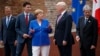 G7 leaders, from left, President of the European Commission Jean-Claude Junker, Canadian Prime Minister Justin Trudeau, German Chancellor Angela Merkel, President Donald Trump, and Italian Prime Minister Paolo Gentiloni, pose for a family photo at the Ancient Greek Theater of Taormina, May 26, 2017, in Taormina, Italy.