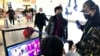 FILE - Travelers pass through a health screening checkpoint at Wuhan Tianhe International Airport, in Wuhan, in southern China's Hubei province, Jan. 21, 2020.