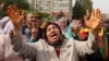 Protesters chant slogans as they protest Saturday's bombing attacks, during a rally in Ankara, Turkey, Sunday, Oct. 11, 2015.
