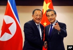 N. Korean Foreign Minister Ri Yong Ho, left, is greeted by his Chinese counterpart Wang Yi prior to their bilateral meeting on the sidelines of the 50th ASEAN Foreign Ministers' Meeting and its Dialogue Partners, Aug. 6, 2017 in suburban Pasay city, south