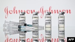 (FILES) This file illustration photo taken on November 17, 2020 shows vials with Covid-19 Vaccine stickers attached and syringes with the logo of US pharmaceutical company Johnson & Johnson. - Pharmaceuticals giant Johnson & Johnson on February 4,…