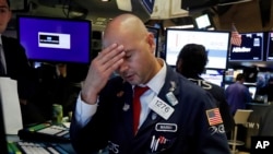 Specialist Mario Picone works on the floor of the New York Stock Exchange, Wednesday, Aug. 14, 2019. The Dow Jones Industrial Average sank 800 points after the bond market flashed a warning sign about a possible recession for the first time since…