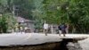 Residents walk on a damaged highway at Loboc township, Bohol province in central Philippines, Oct. 16, 2013.