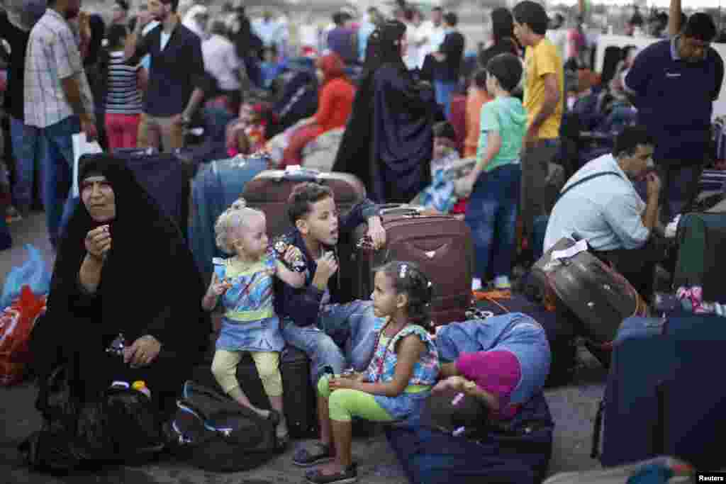 Palestinians wait to cross into Egypt at Rafah crossing between Egypt and southern Gaza Strip, Aug. 24, 2013.