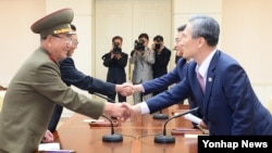 지난 8월 25일 판문점에서 '무박4일' 마라톤 협상을 마친 남북한 대표가 악수하고 있다. 오른쪽부터 한국 측 대표인 김관진 국가안보실장과 홍용표 통일부 장관, 북측 대표인 김양건 당 비서와 황병서 군 총정치국장.