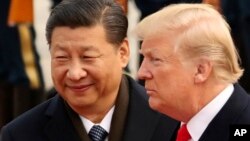 FILE - U.S. President Donald Trump and Chinese President Xi Jinping participate in a welcome ceremony at the Great Hall of the People in Beijing, China, Nov. 9, 2017.