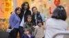 A family poses for a photograph in the World Square shopping center located in central Sydney, Australia, June 26, 2017.