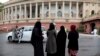 Indian Muslims stand outside Parliament House in New Delhi, India, Friday, July 26, 2019. 