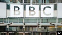 FILE - The BBC sign outside the headquarters of the organization, in London, July 19, 2017. 