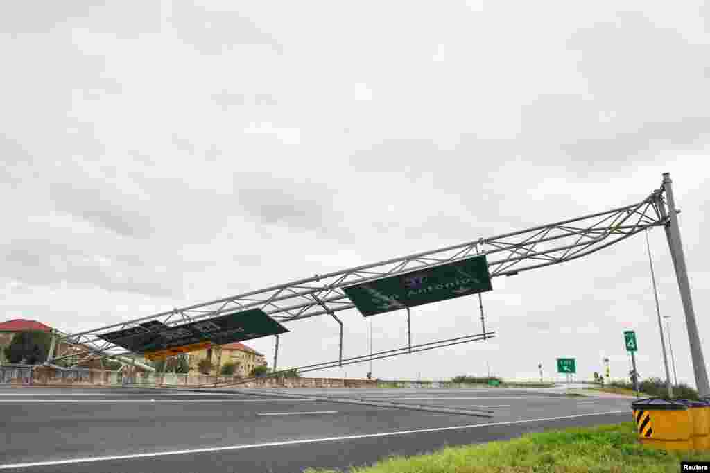 A collapsed overhead gantry lies across Interstate 37, blocking the highway due to damage caused by Hurricane Harvey in Corpus Christie, Texas, Aug. 26, 2017.