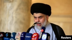 Iraqi Shi'ite cleric Muqtada al-Sadr delivers a sermon to worshippers during Eid al-Fitr prayers at the Kufa mosque near Najaf, June 5, 2019. 